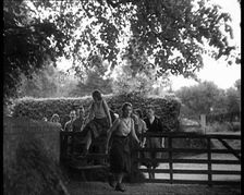 Hikers Climbing over a Gate, 1933. Creator: British Pathe Ltd