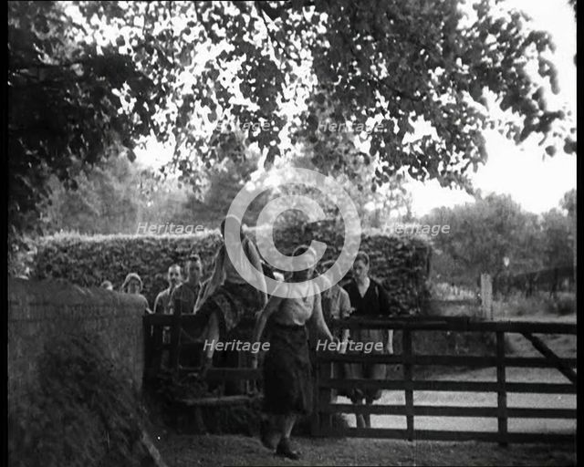 Hikers Climbing over a Gate, 1933. Creator: British Pathe Ltd.