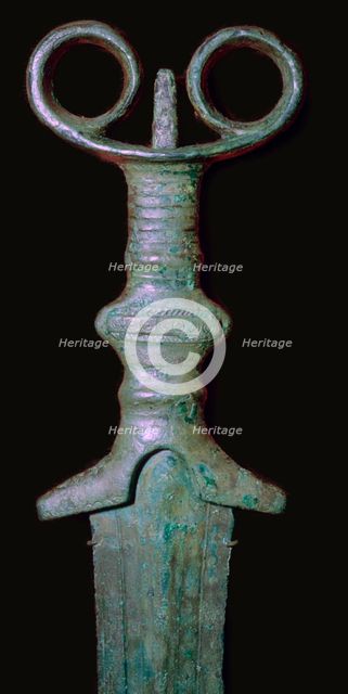 Hilt of an early bronze sword, 7th century BC.