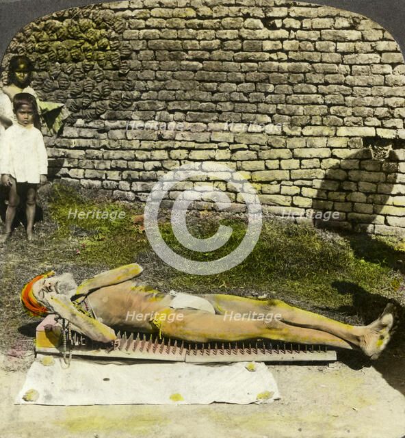 Hindu devotee on a bed of nails near the shrine of Kali, Calcutta, India, early 20th century(?). Artist: Underwood & Underwood