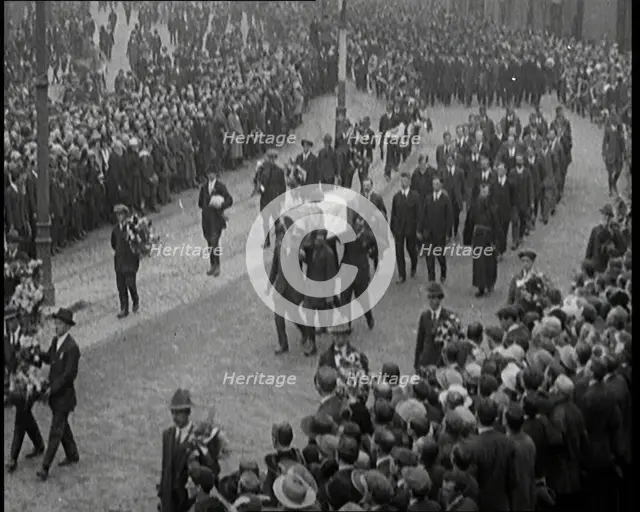 Huge Crowds Watching the Funeral Procession of Terence MacSwiney. His Coffin Is Draped..., 1920. Creator: British Pathe Ltd.