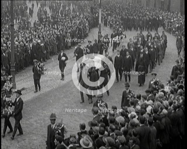 Huge Crowds Watching the Funeral Procession of Terence MacSwiney. His Coffin Is Draped..., 1920. Creator: British Pathe Ltd.