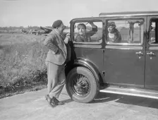 Hugh McConnell, Sammy Davis and Mrs Davis with an Austin 20/6 landaulette at Brooklands, 1931. Artist: Bill Brunell