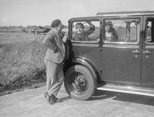 Hugh McConnell, Sammy Davis and Mrs Davis with an Austin 20/6 landaulette at Brooklands, 1931. Artist: Bill Brunell