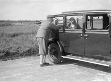 Hugh McConnell, Sammy Davis and Mrs Davis with an Austin 20/6 landaulette at Brooklands, 1931. Artist: Bill Brunell