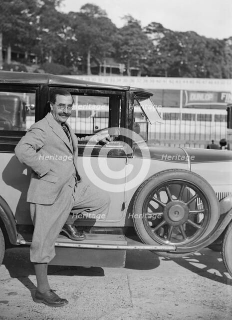 Hugh McConell beside a car, Brooklands, 3 August 1931. Artist: Bill Brunell.