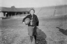 Hughey Gold [child with football], between c1910 and c1915. Creator: Bain News Service
