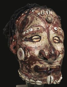 Human skull with features modelled in clay and painted, from New Guinea