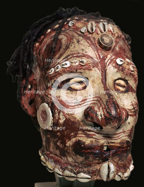 Human skull with features modelled in clay and painted, from New Guinea. Artist: Unknown