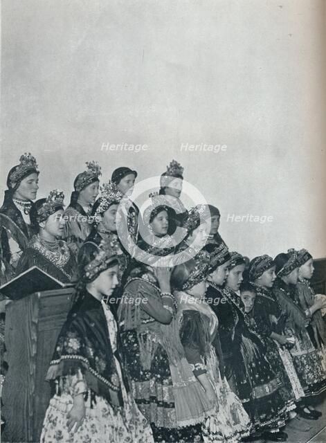 'Hungarian Peasant Girls Singing in Church', c1932. Artist: Rudolf Balogh.