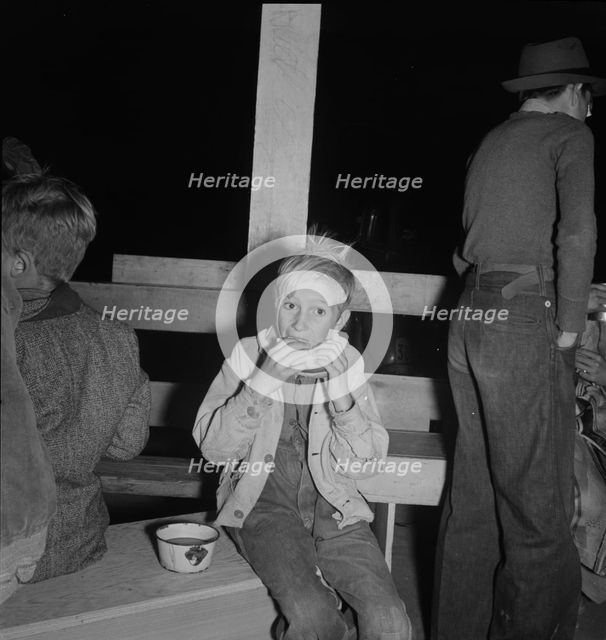 Hungry boy at the Halloween party for migrant workers, Shafter migrant camp, California, 1938. Creator: Dorothea Lange.