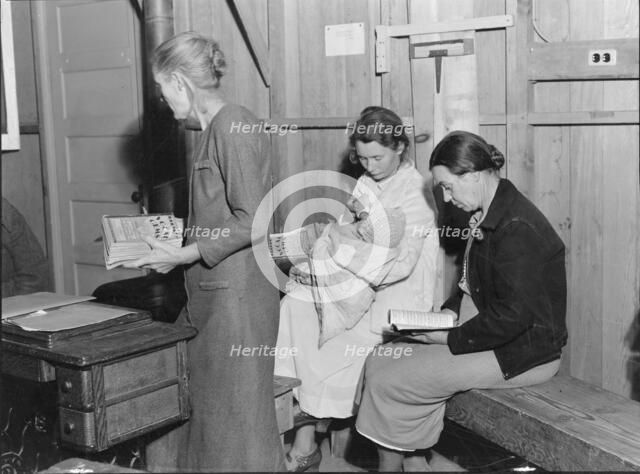 Hymn singing at meeting of Mothers' Club in Arvin migrant camp, California, 1938. Creator: Dorothea Lange.