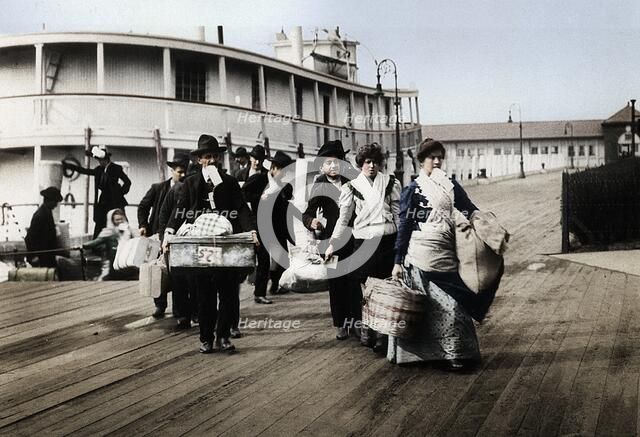 Immigrants to the USA landing at Ellis Island, New York, c1900. Artist: Unknown.