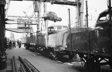 Imported cars being loaded onto railway goods wagons, Landskrona Harbour, Sweden, 1935