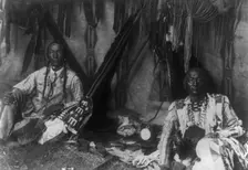 In a Piegan lodge, c1910. Creator: Edward Sheriff Curtis