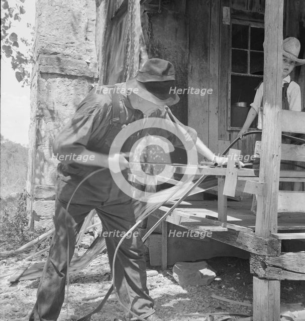 In Arkansas Hills (Ozarks) near Seligman, Missouri, splitting hickory for chair-bottoms, 1938. Creator: Dorothea Lange.