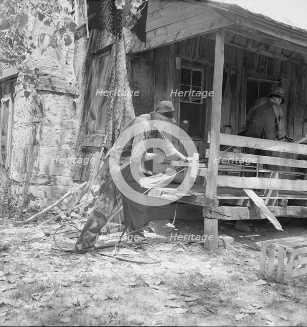 In Arkansas Hills (Ozarks) near Seligman, Missouri, splitting hickory for chair-bottoms, 1938. Creator: Dorothea Lange.