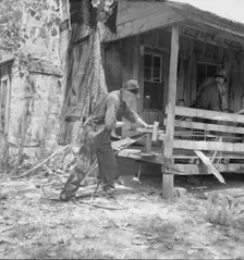 In Arkansas Hills (Ozarks) near Seligman, Missouri, splitting hickory for chair-bottoms, 1938. Creator: Dorothea Lange