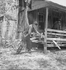 In Arkansas Hills (Ozarks) near Seligman, Missouri, splitting hickory for chair-bottoms, 1938. Creator: Dorothea Lange