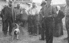 In front of Haly's Road House, Jim Haly holds a dog, between c1900 and 1916. Creator: Unknown