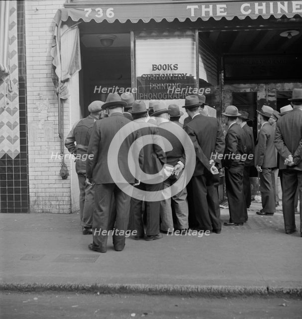 In front of the local paper of San Francisco's Chinatown, 1938. Creator: Dorothea Lange.
