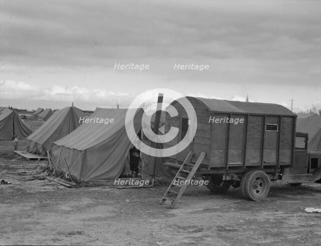 In mobile camp at end of season, cold day, FSA camp, Merrill, Klamath County, Oregon, 1939. Creator: Dorothea Lange.