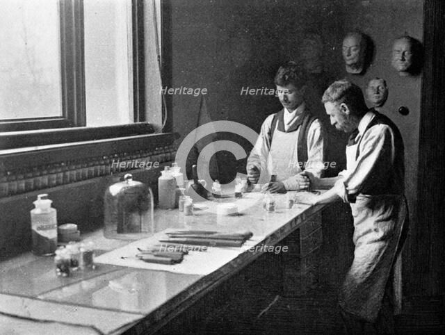 In Professor Herkomer's enamelling studio, grinding colours, 1899. Artist: Unknown