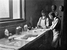 In Professor Herkomer's enamelling studio, grinding colours, 1899