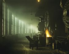 In the roundhouse at a Chicago and North Western Railroad yard, Chicago, Ill., 1942. Creator: Jack Delano
