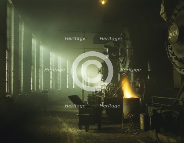 In the roundhouse at a Chicago and North Western Railroad yard, Chicago, Ill., 1942. Creator: Jack Delano.
