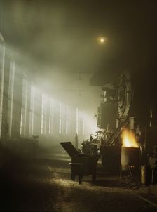 In the roundhouse at a Chicago and North Western Railroad yard, Chicago, Ill., 1942. Creator: Jack Delano