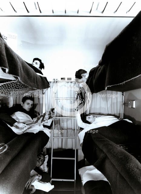 Interior of a traveler car wagon with bunks, 1950.