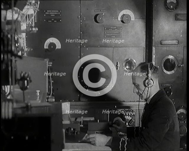 Interior of a Ship at Sea With Man at Work Operating a Communication System, 1920s. Creator: British Pathe Ltd.