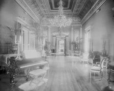 Interior view of a large hall with piano, chairs, small tables, and..., Washington, DC, c1890 - 1910 Creator: Frances Benjamin Johnston