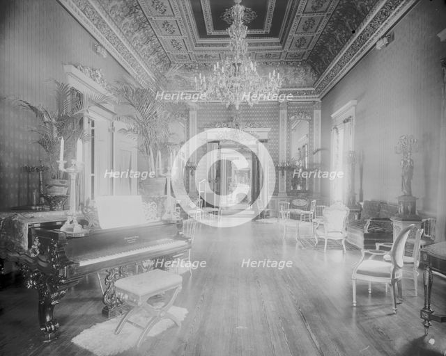 Interior view of a large hall with piano, chairs, small tables, and..., Washington, DC, c1890 - 1910 Creator: Frances Benjamin Johnston.