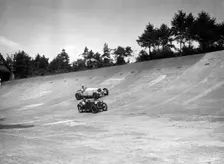 Invicta and Austin Ulster racing on the Members Banking at Brooklands. Artist: Bill Brunell