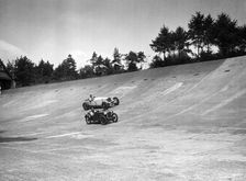 Invicta and Austin Ulster racing on the Members Banking at Brooklands. Artist: Bill Brunell