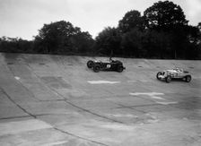 Invicta and Vauxhall 30/98 racing on the banking at an Inter-Club Meeting, Brooklands, 20 June 1931. Artist: Bill Brunell