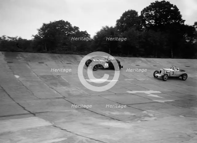 Invicta and Vauxhall 30/98 racing on the banking at an Inter-Club Meeting, Brooklands, 20 June 1931. Artist: Bill Brunell.