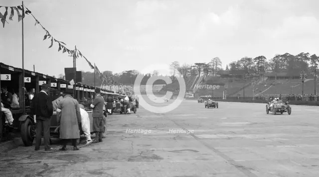 Invicta leading a Riley 9 Brooklands in the JCC Double Twelve race, Brooklands, 8/9 May 1931. Artist: Bill Brunell.