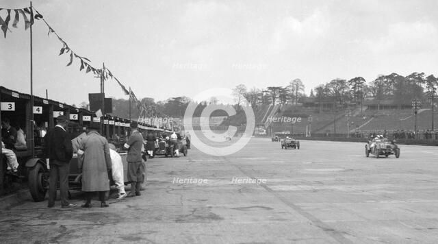 Invicta leading a Riley 9 Brooklands in the JCC Double Twelve race, Brooklands, 8/9 May 1931. Artist: Bill Brunell.