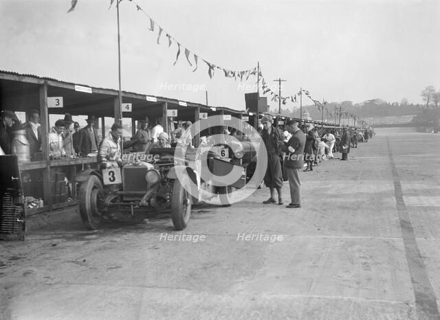 Invicta of FH Cairnes and George Field in the pits at the JCC Double Twelve race, Brooklands, 1931. Artist: Bill Brunell.