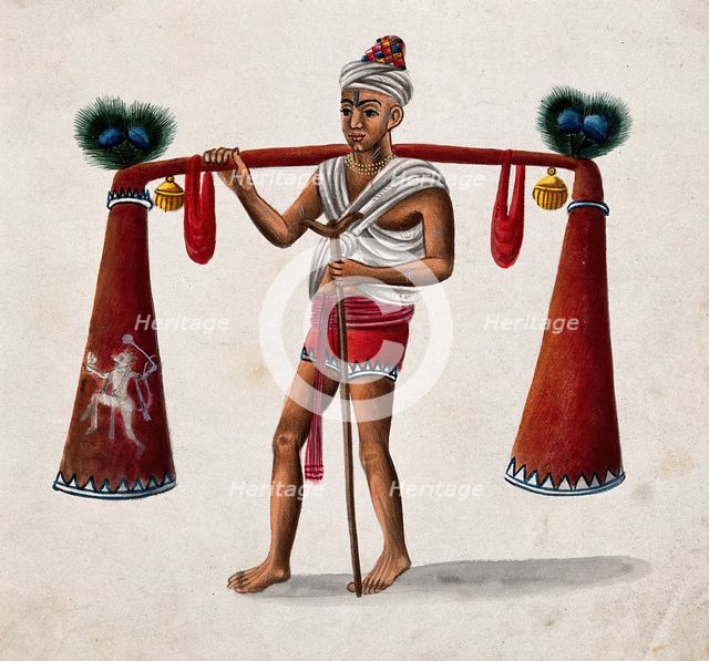 India: a man with a crutch carrying tubes decorated with bells and..., (between 1800 and 1899?). Creator: Unknown.