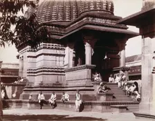 Indian men sitting on steps outside a domed building in Bombay during an outbreak of plague, 1896/7. Creator: Unknown