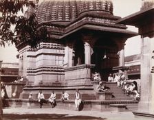 Indian men sitting on steps outside a domed building in Bombay during an outbreak of plague, 1896/7. Creator: Unknown