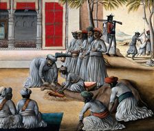 Indian men slaughtering a camel; a sheep being skinned in the background. Creator: Unknown