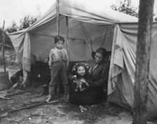 Indian children and mother at entrance of tent, between c1900 and 1927. Creator: Unknown