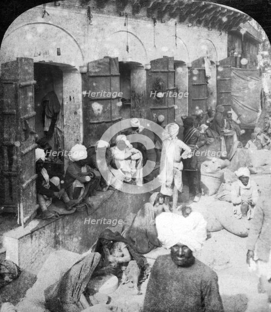 Indian women grinding corn between two round stones, Delhi, India, 1900s.Artist: Rose Stereographs