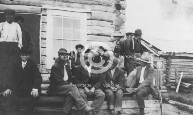 Indigenous peoples outside of log building, between c1900 and 1916. Creator: Unknown.
