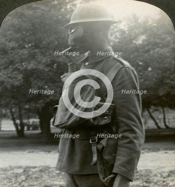 Infantry fitted with the latest gas marks and steel helmets, World War I, 1915-1918.Artist: Realistic Travels Publishers